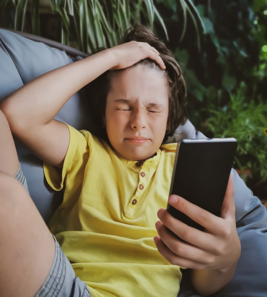 Boy frustrated holding a phone